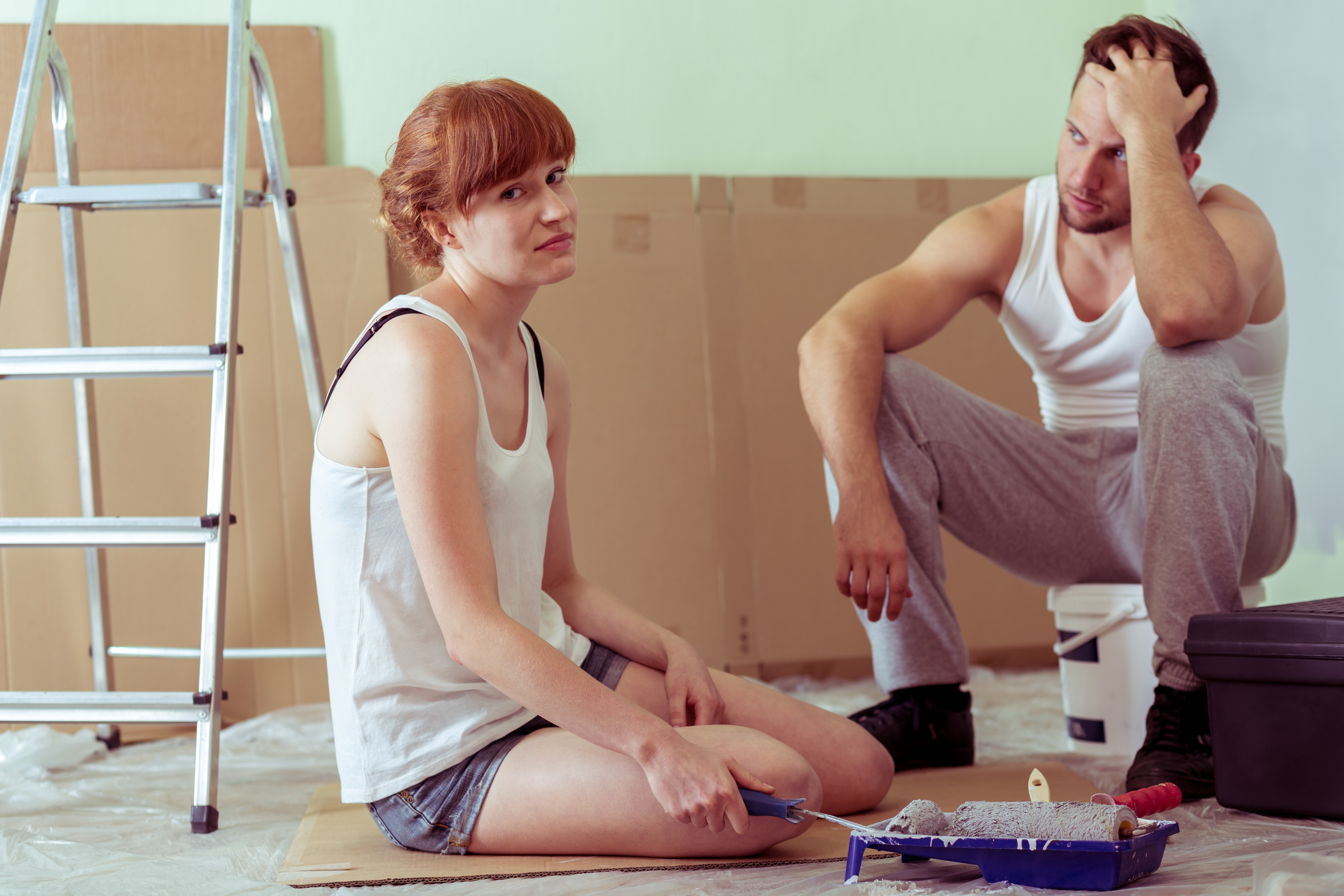 Shot of a tired young couple sitting on a floor in a flat they redecorate