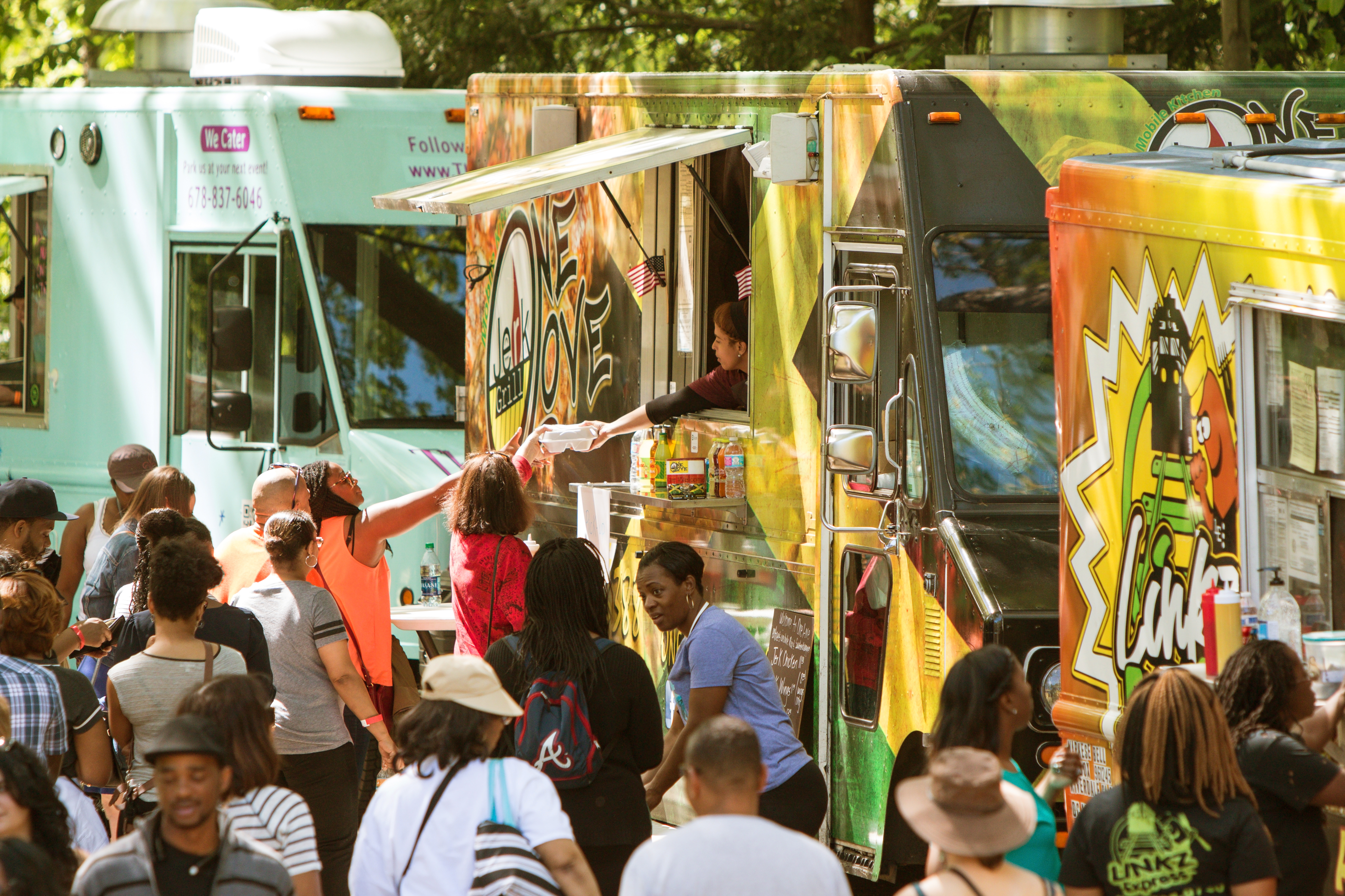 Photo of people enjoying a lineup of food trucks